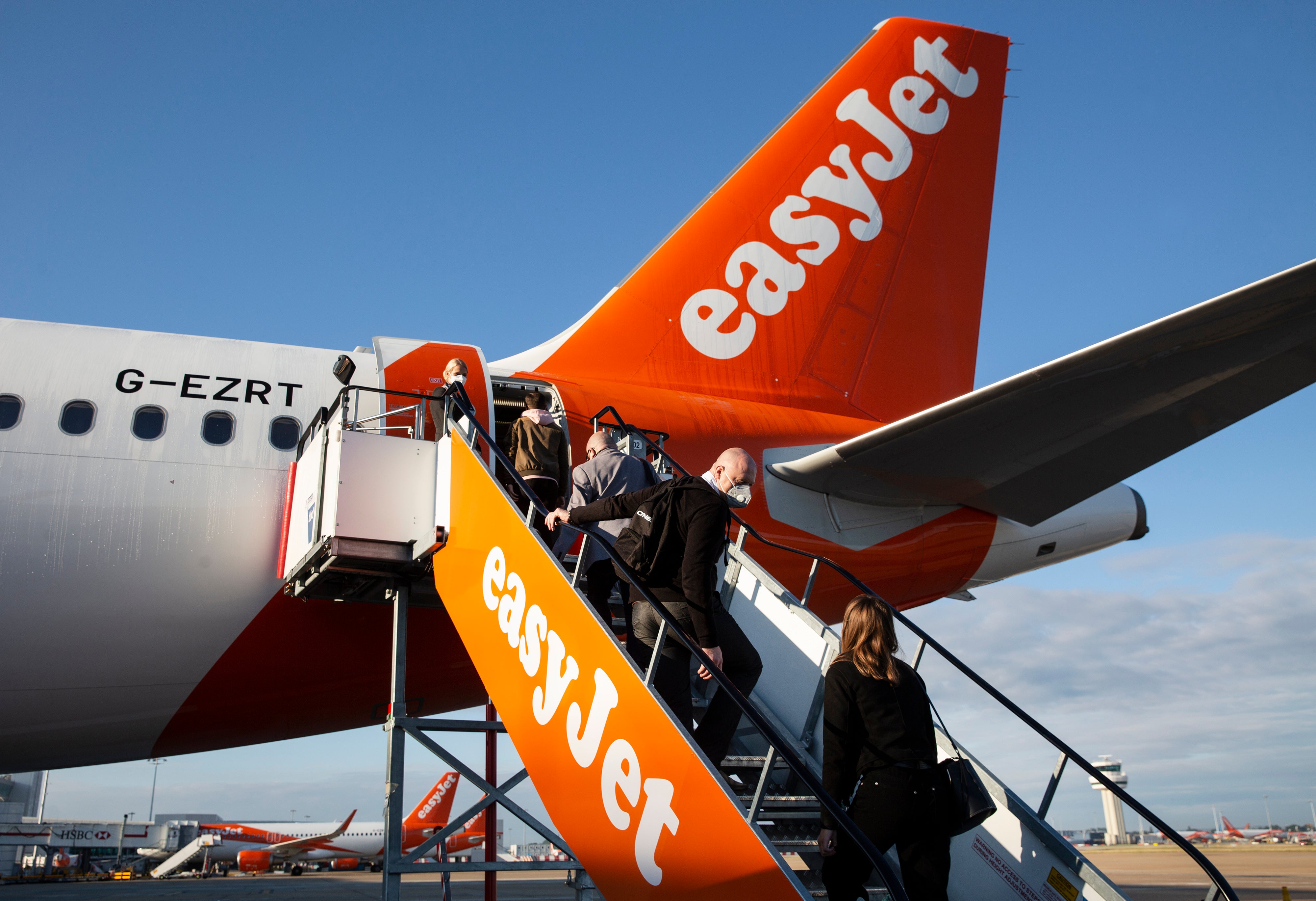 Passengers board an easyJet plane