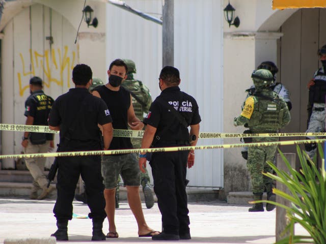 <p>Police officers and soldiers are pictured during an operation one day after the murder of two men and where a tourist was injured during the shooting at Tortugas beach in Cancun, Mexico June 12, 2021. </p>