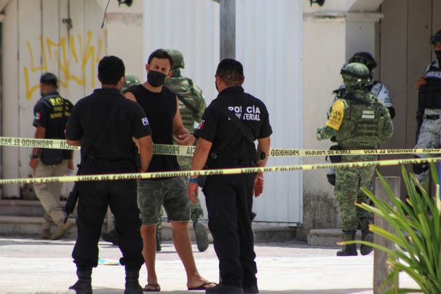 <p>Police officers and soldiers are pictured during an operation one day after the murder of two men and where a tourist was injured during the shooting at Tortugas beach in Cancun, Mexico June 12, 2021. </p>
