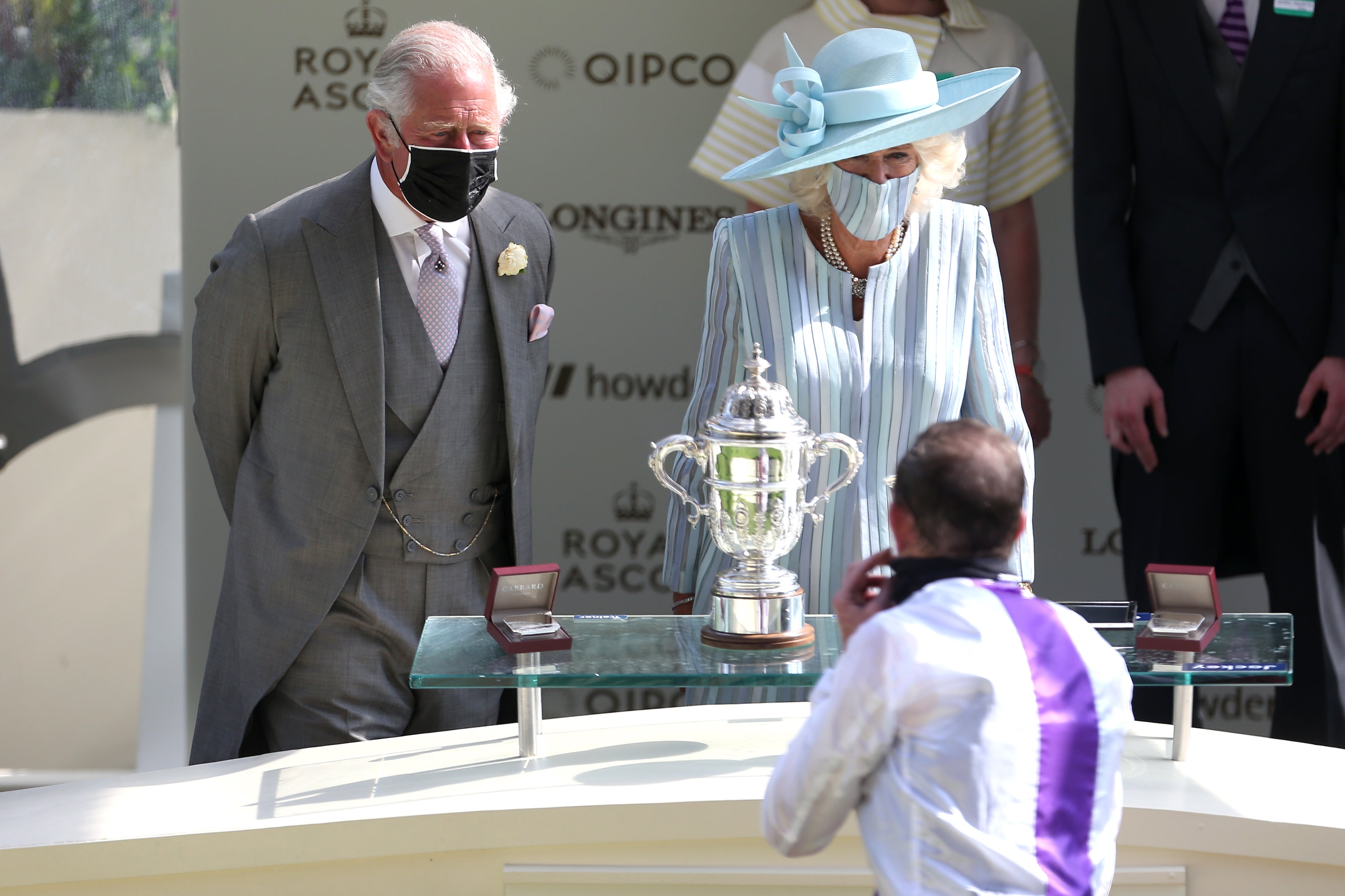 The Prince of Wales and the Duchess of Cornwall speak to jockey Kevin Manning