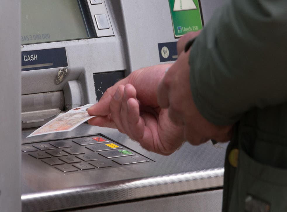 A man withdrawing money from an ATM (Aaron Chown/PA)