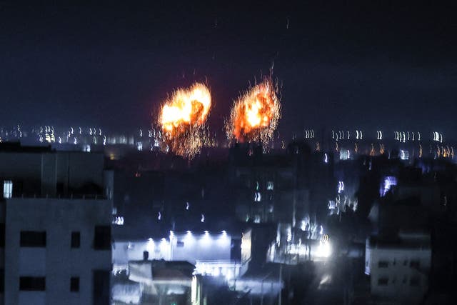 <p>Explosions lit up the night sky about building in Gaza city as Israeli forces shelled the Palestinian enclave, in response to incendiary balloons.</p>
