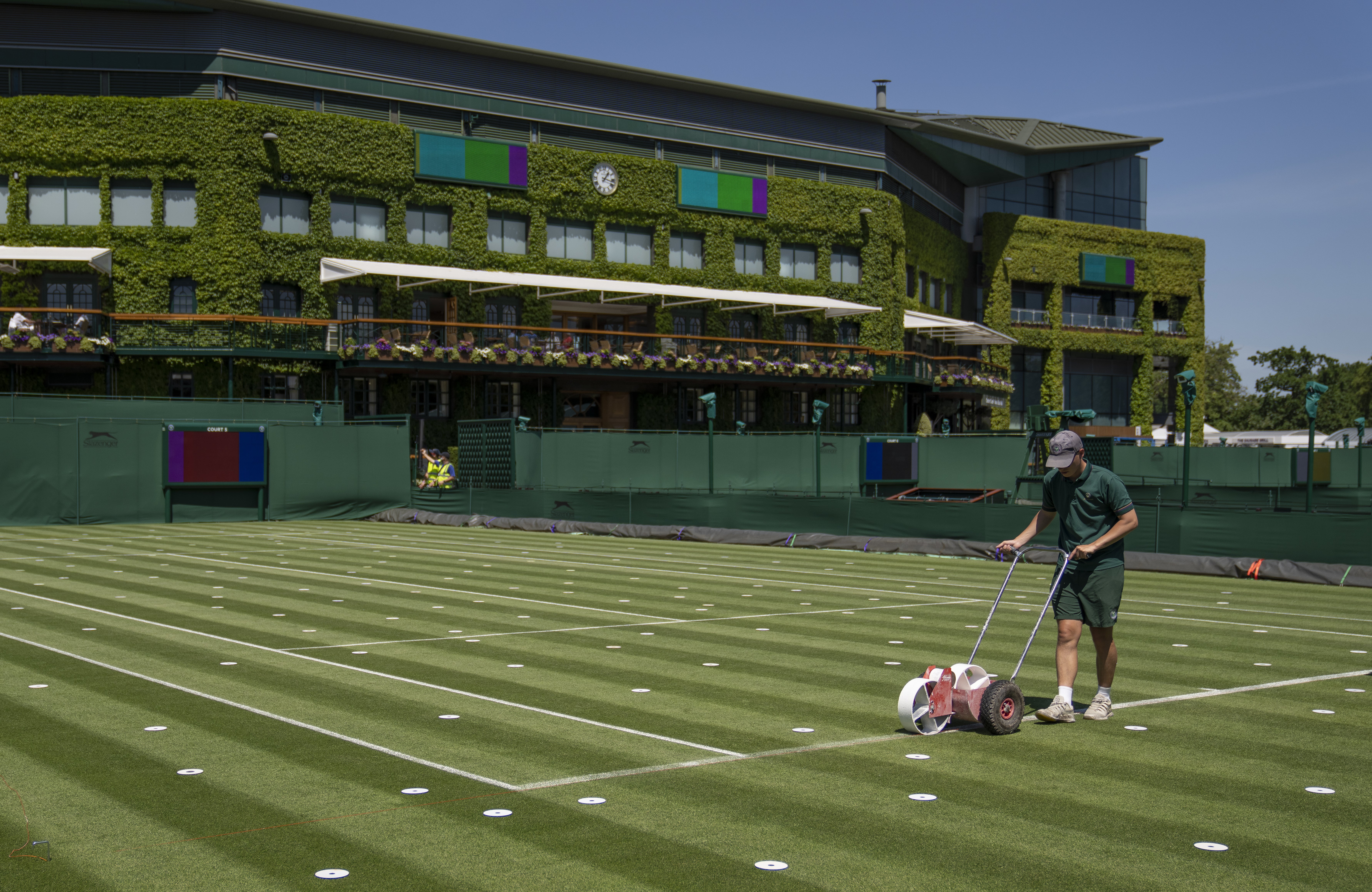 Lines are painted on the outside courts at Wimbledon
