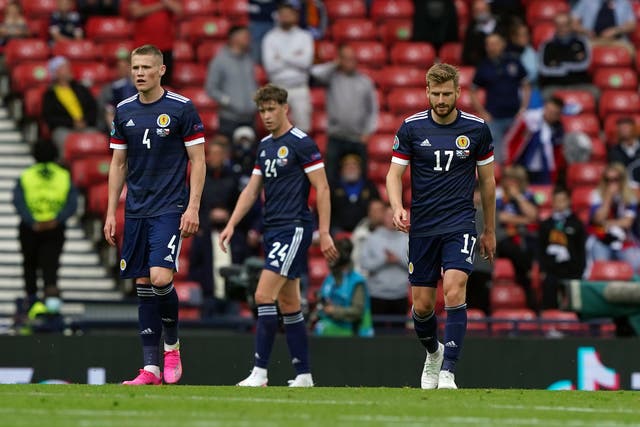 <p>Scotland’s Scott McTominay, Jack Hendry and Stuart Armstrong stand dejected at Hampden Park</p>