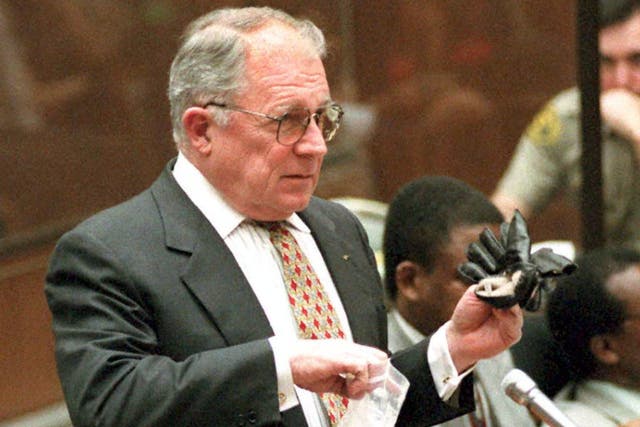 <p>The attorney holds up the infamous black glove in 1995</p>