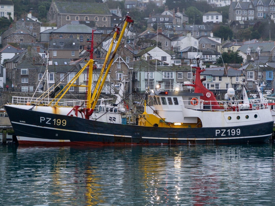 Beam trawler moored alongside the pier in Newlyn at high water