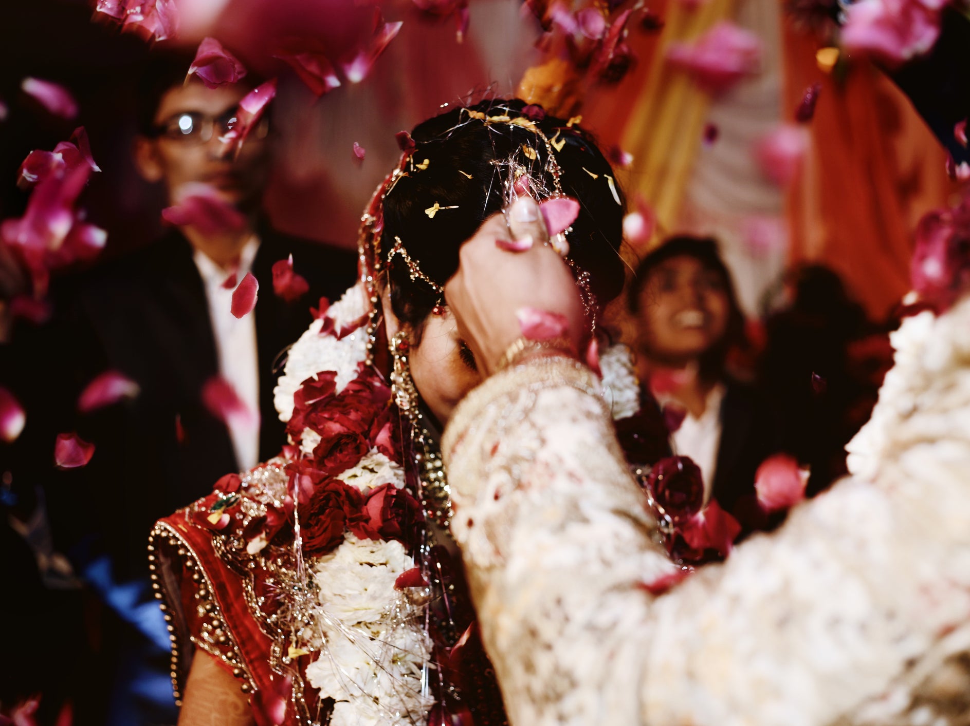 File: A bride and groom exchange garlands in a wedding ritual in India