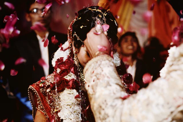 <p>File: A bride and groom exchange garlands in a wedding ritual in India  </p>