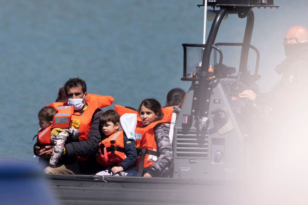Border Force officials guide newly arrived migrants into port after being picked up in a dinghy in the English Channel on 9 June, 2021