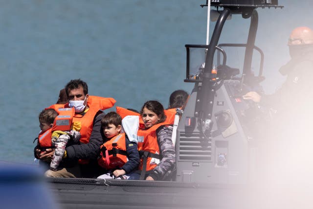 <p>Border Force officials guide newly arrived migrants into port after being picked up in a dinghy in the English Channel on 9 June, 2021</p>