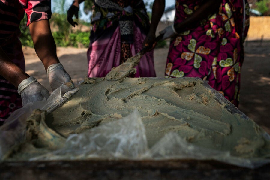 The soap mix is applied to the mould which is lined with wax paper