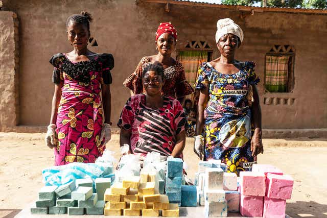 <p>Germaine, centre, with her soap-making team</p>