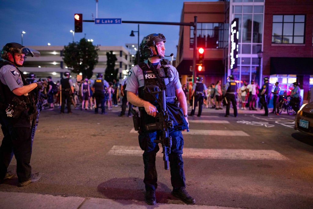 Police with assault rifles and silencers clear out memorial to slain Black man in Minneapolis