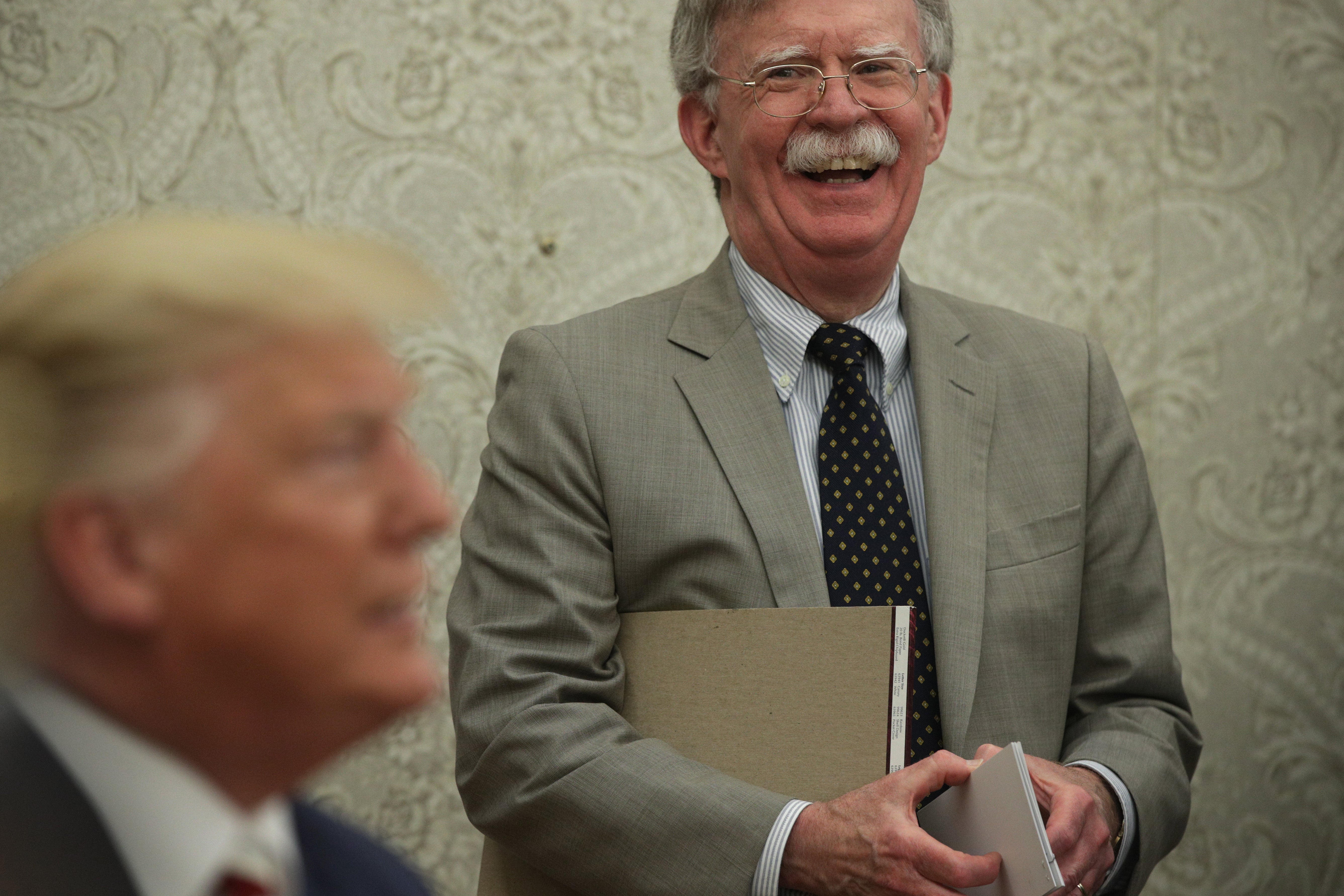 John Bolton with Donald Trump in the foreground