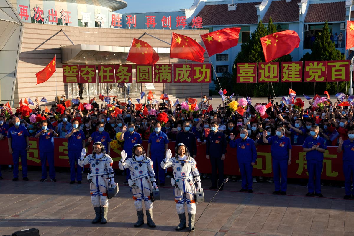 China launches first three-man crew to new space station 