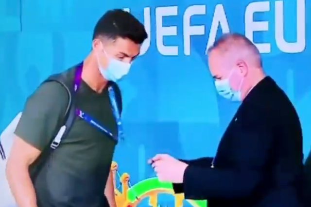 <p>Cristiano Ronaldo is stopped by a security guard in Budapest</p>