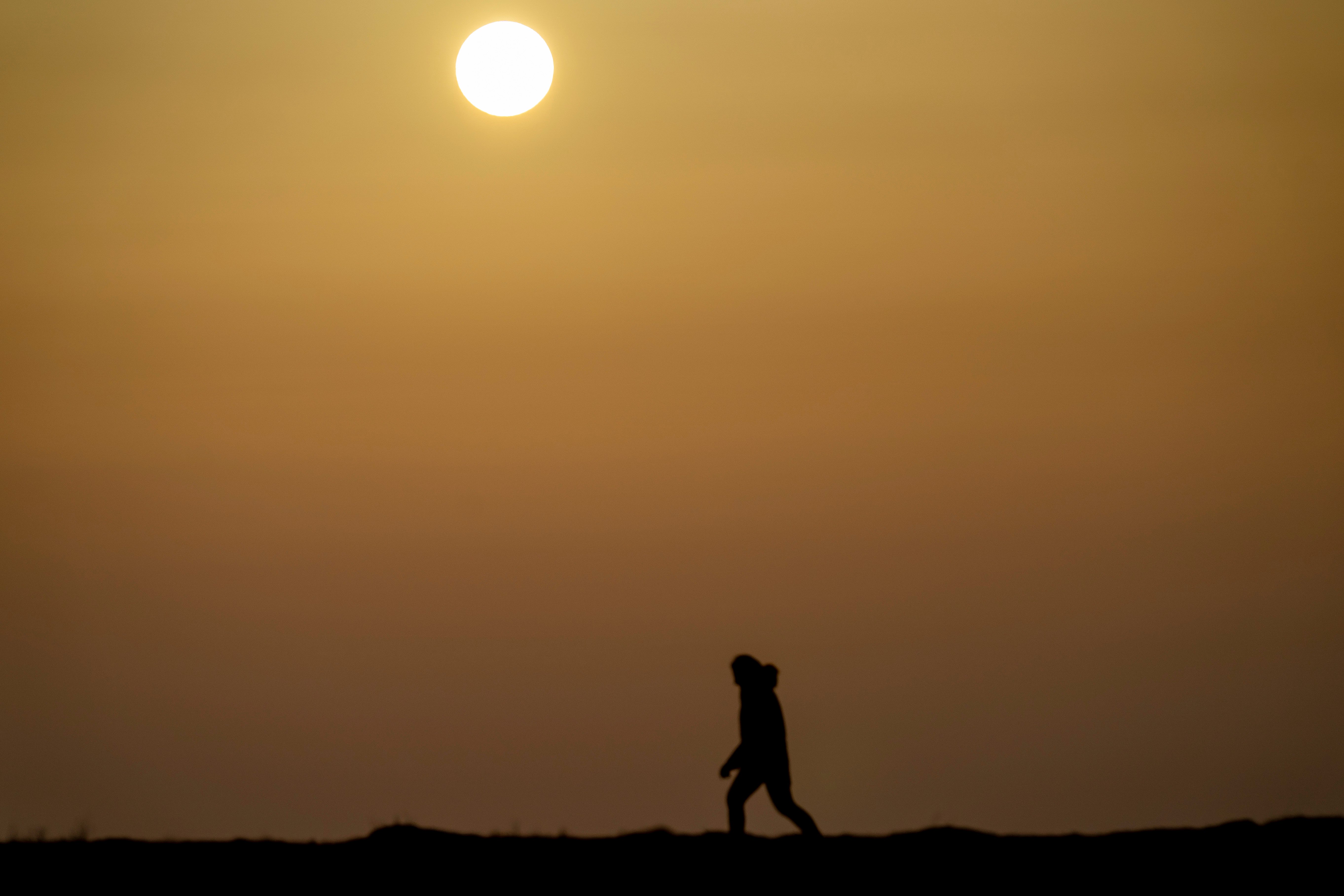 The sun rises amidst clouds of dust coming from the Sahara in Koge, Denmark, on February 23, 2021