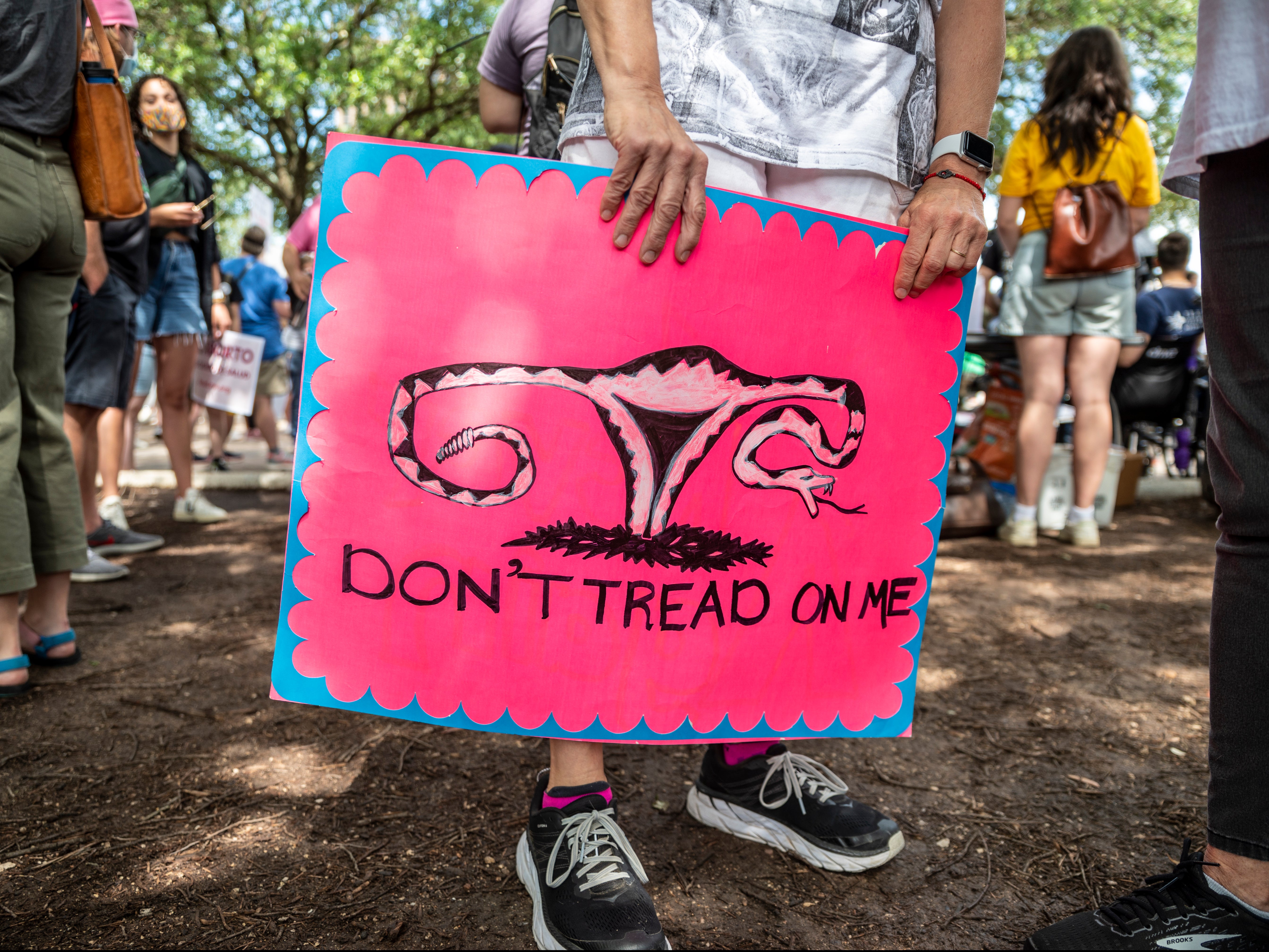 A protester holds a sign before a protest outside the Texas state capitol on 29 May 2021 in Austin, Texas