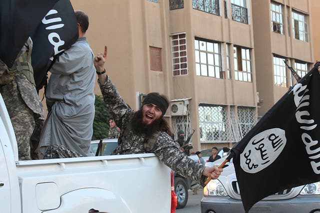 <p>Isis parading in the northern Syrian city of Raqa in 2014</p>