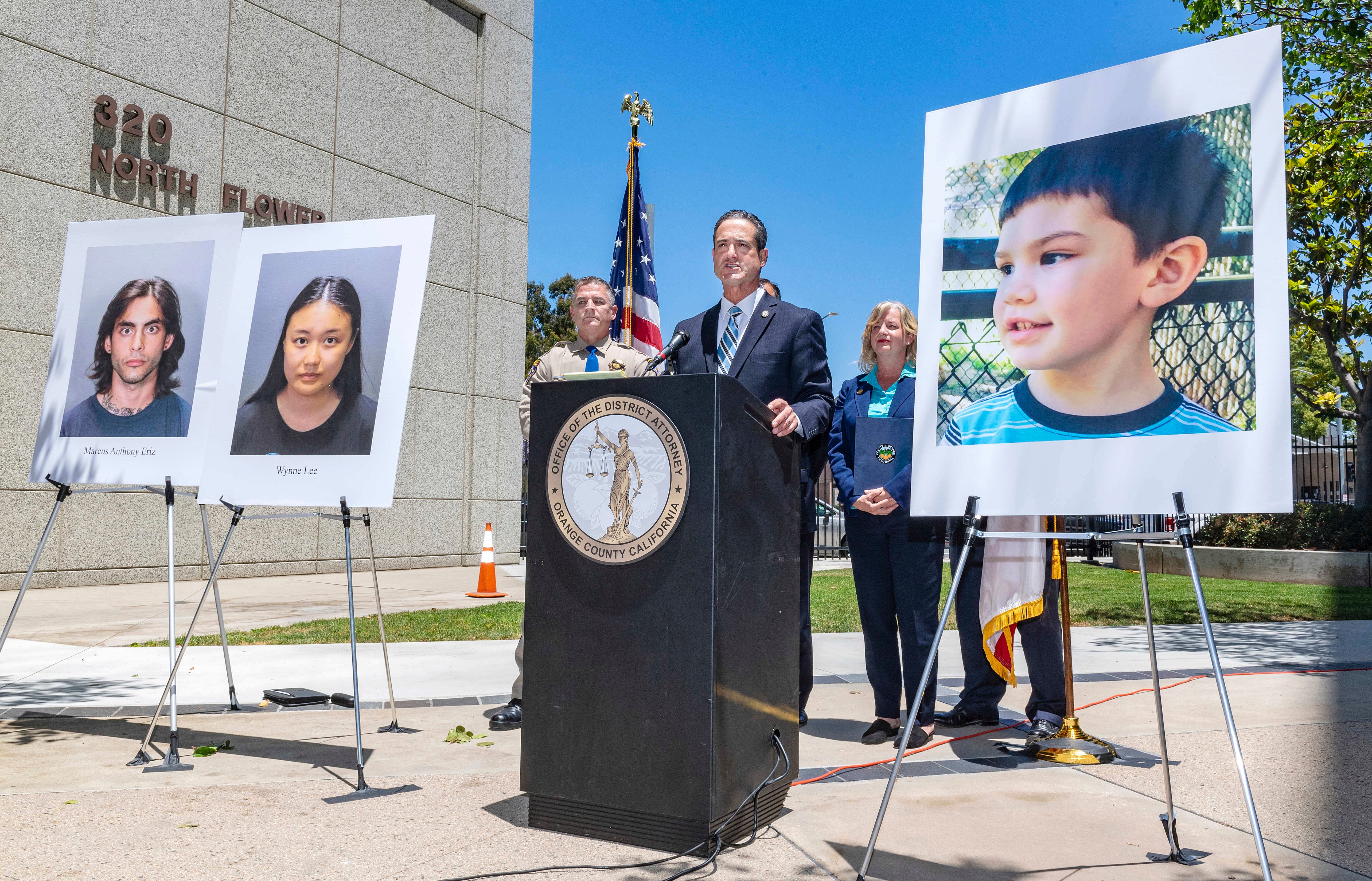 Orange County District Attorney Todd Spitzer announces charges filed against suspects Marcus Anthony Eriz, left, and Wynne Lee, second from left, in the death of Aiden Leos, right