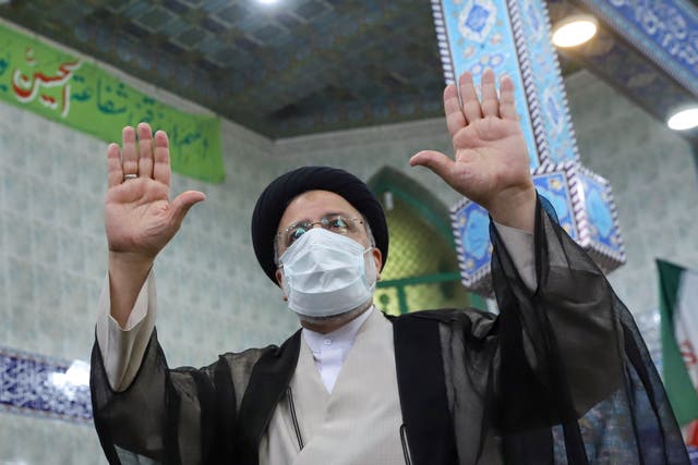 <p>Presidential candidate Ebrahim Raisi gestures after casting his vote</p>