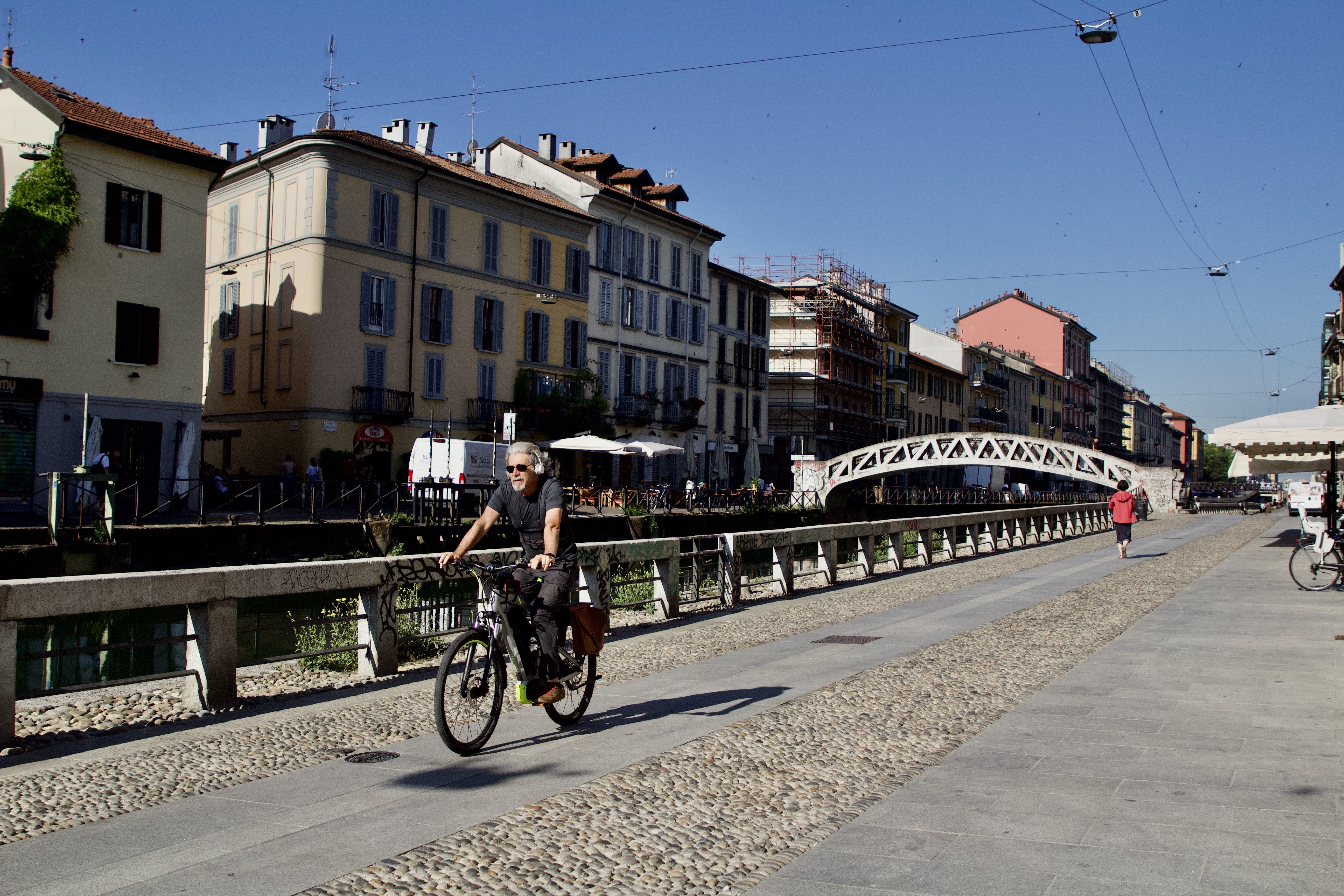 Cyclist rides along the canal in Navigli district