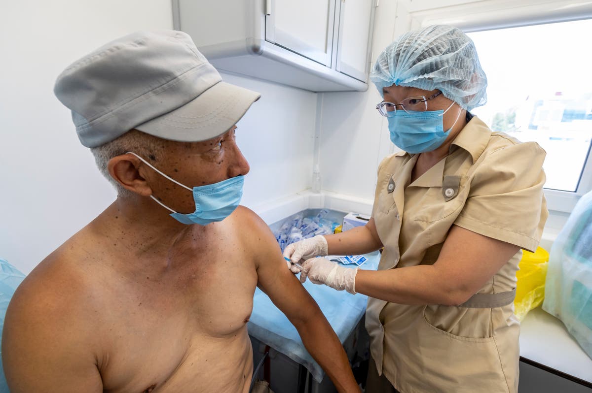 The Latest: Israel to share vaccine doses with Palestinians