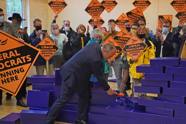 <p>Ed Davey smashes a symbolic blue wall after the by-election win in Chesham and Amersham for the Liberal Democrats</p>