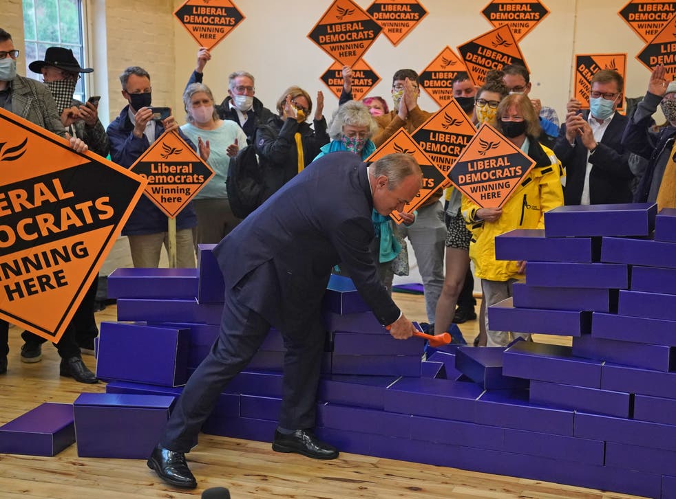 <p>Ed Davey smashes a symbolic blue wall after the by-election win in Chesham and Amersham for the Liberal Democrats</p>