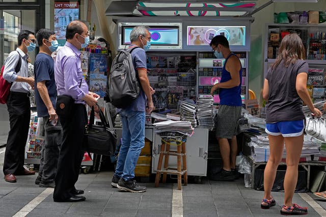 <p>People queue up to buy the Apple Daily newspaper in Hong Kong</p>