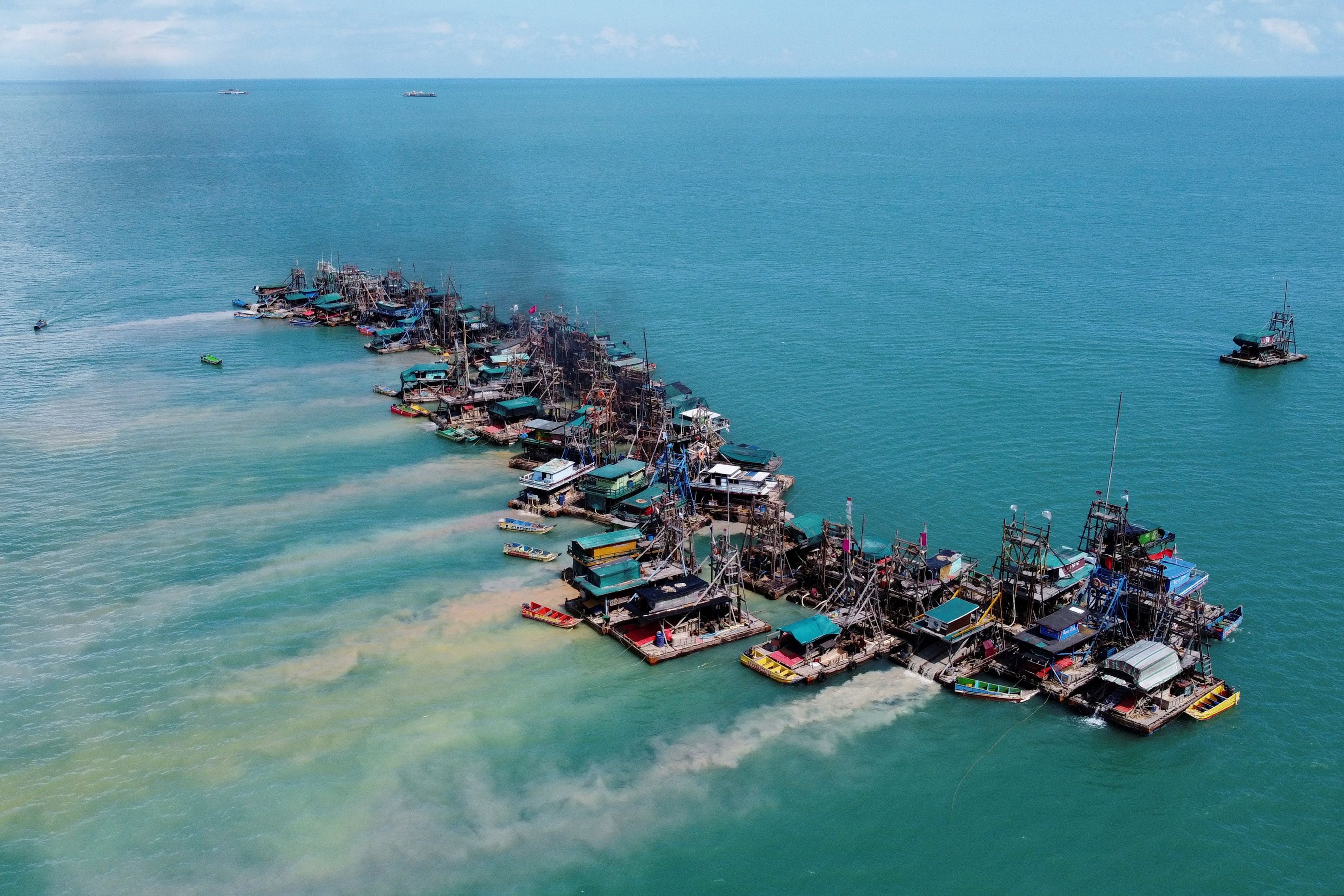 Wooden pontoons equipped to dredge the seabed for deposits of tin ore off the coast of Toboali, Indonesia