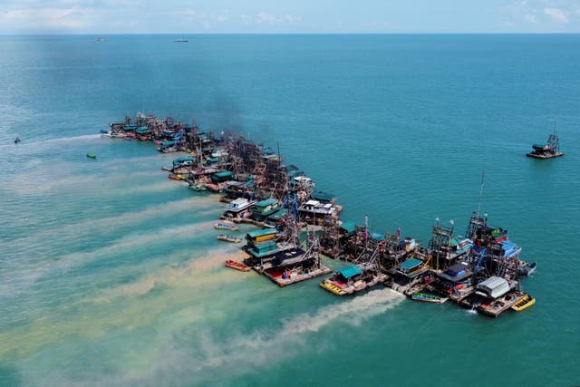 <p>Wooden pontoons equipped to dredge the seabed for deposits of tin ore off the coast of Toboali, Indonesia</p>