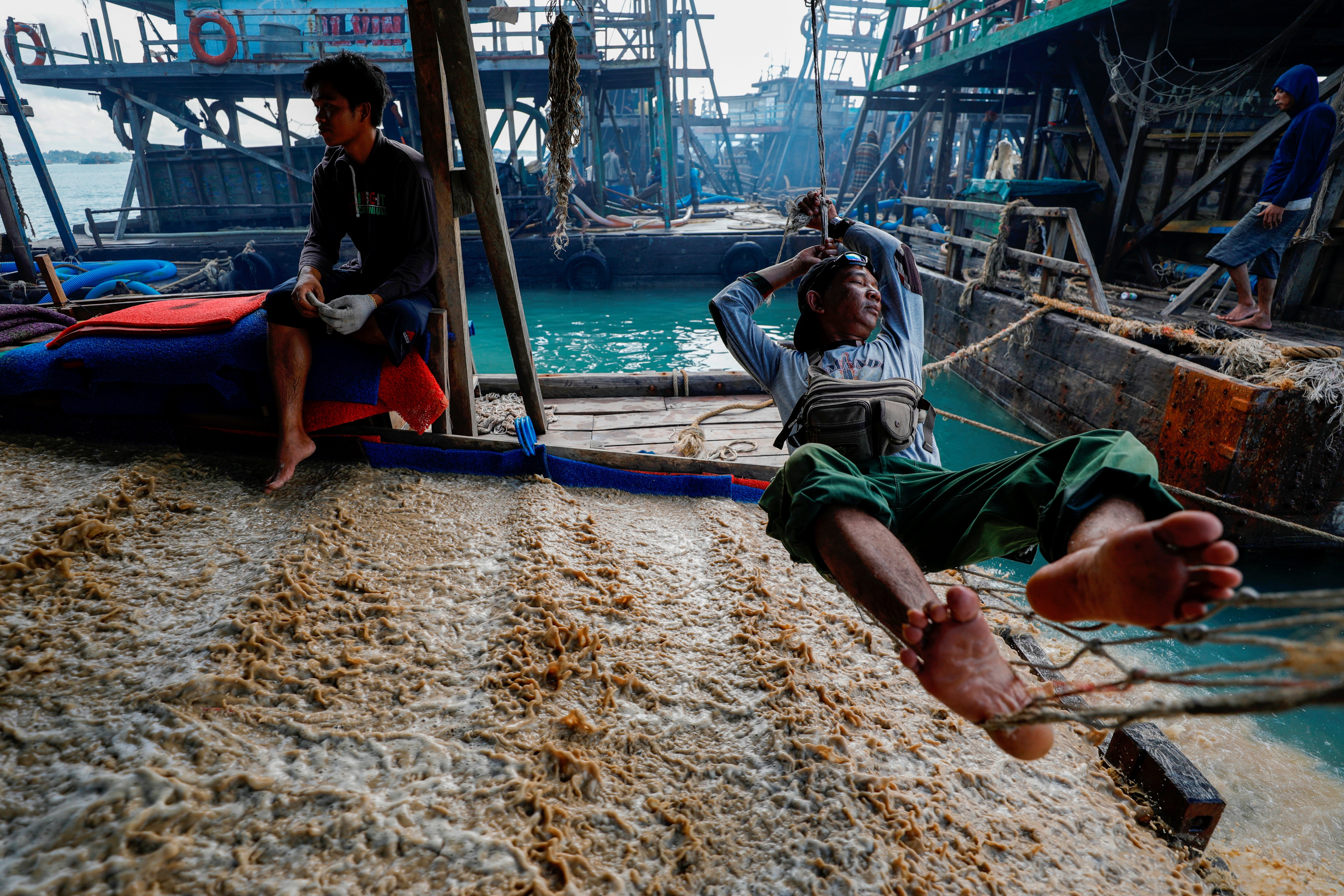 Amirudin, 43, a field supervisor of the state tin mining company PT Timah, rests on a makeshift hammock