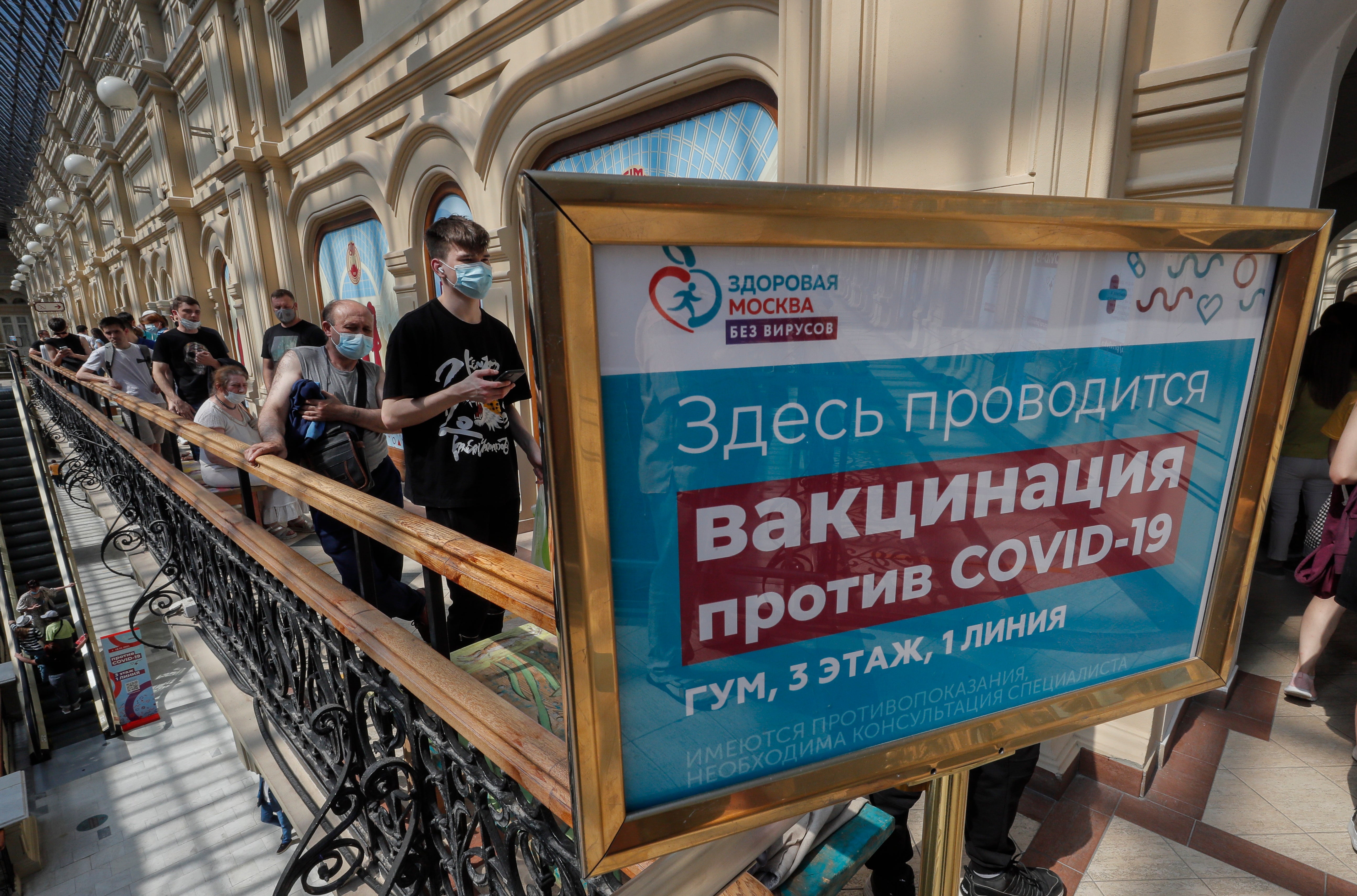 Russian people stand in line waiting to receive an injection of Russia’s Sputnik V