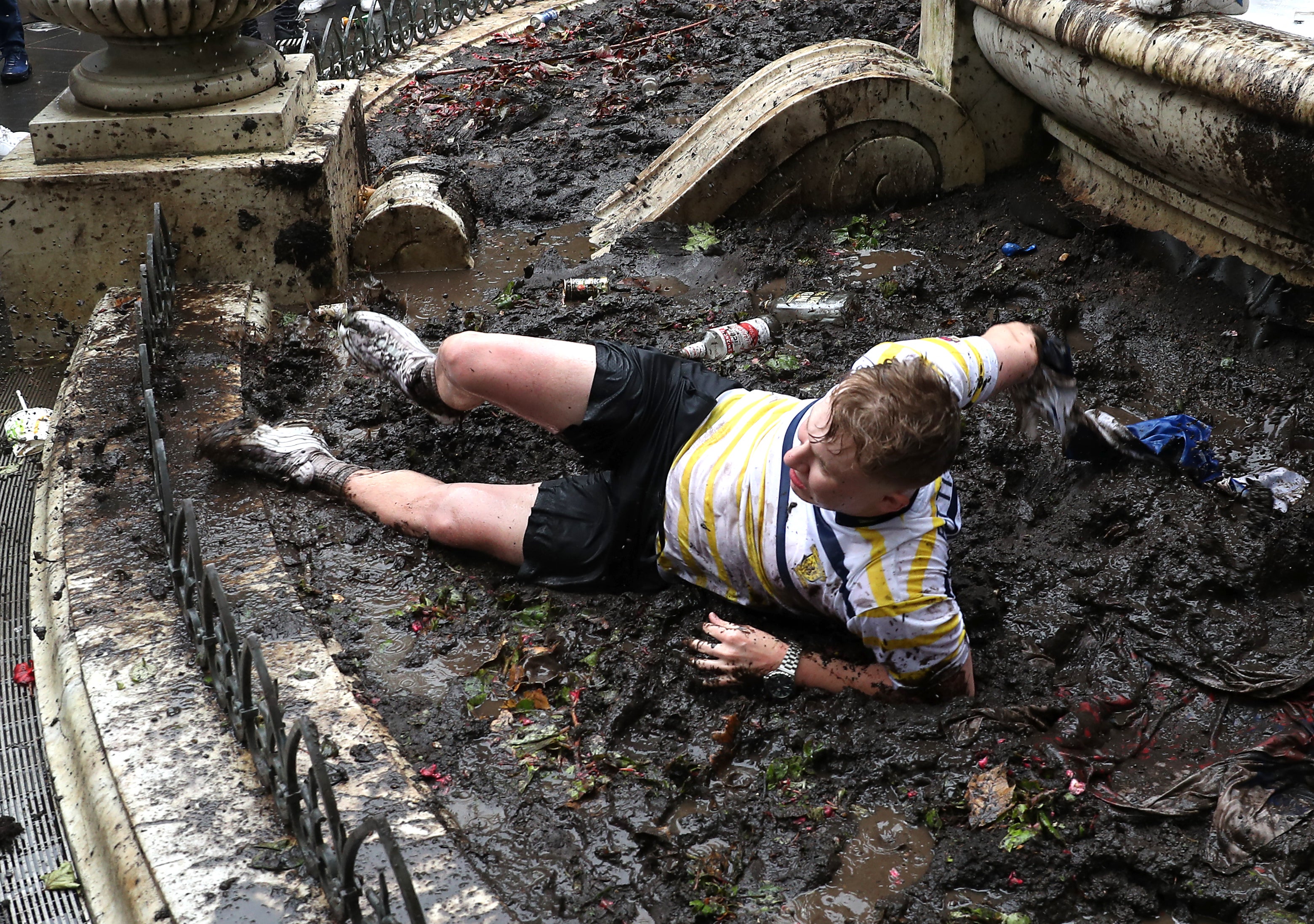 Peaked too soon? One fan was pictured rolling around in the mud.