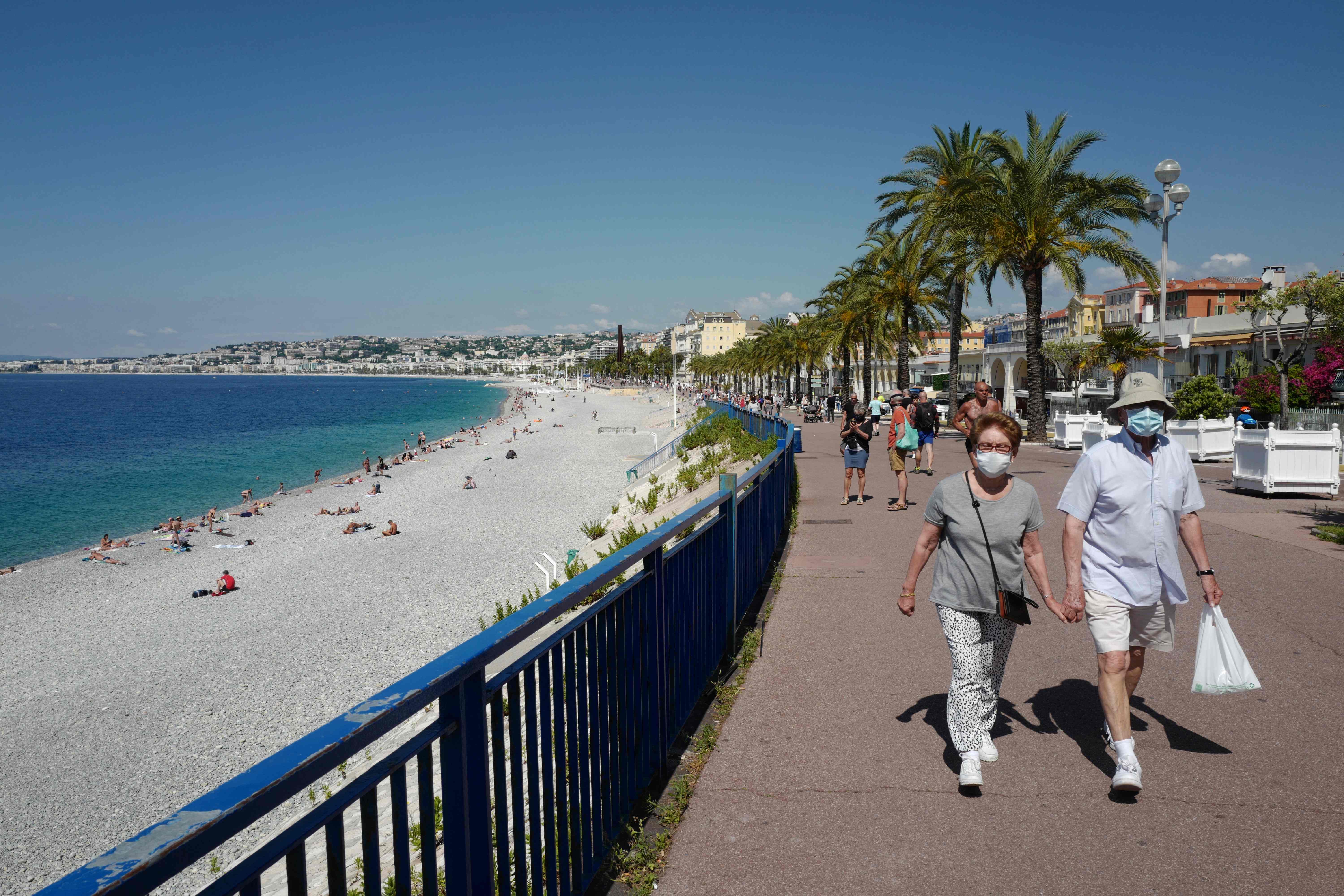 People walk along the Promenade des Anglais in Nice in southern France, in the region where Mr Mariani’s Rassemblement National hopes to secure victory