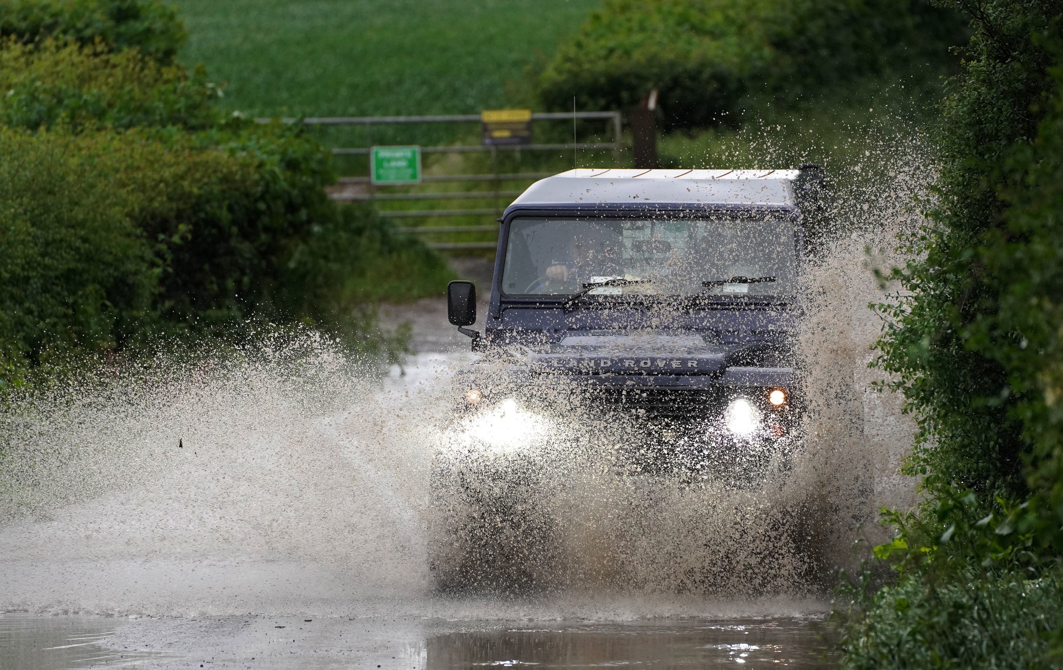 A car drives through a flooded road near Chesham, Buckinghamshire