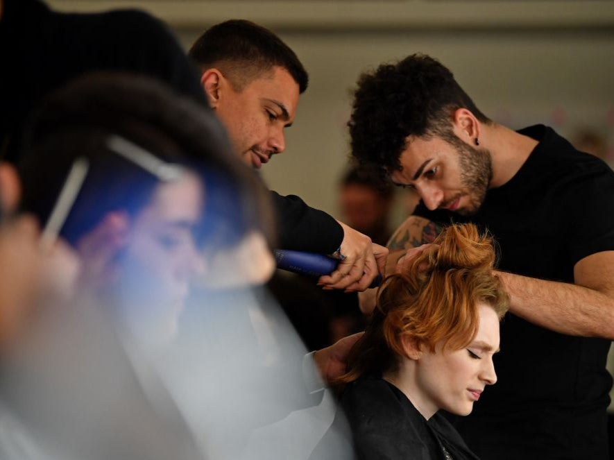 Models have their hair and make-up prepared before presenting creations by fashion house Richard Quinn during the catwalk show for their Autumn/Winter 2020 collection on the second day of London Fashion Week in London