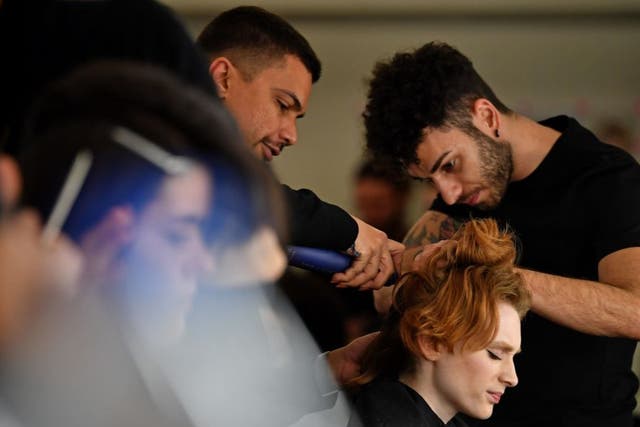 <p>Models have their hair and make-up prepared before presenting creations by fashion house Richard Quinn during the catwalk show for their Autumn/Winter 2020 collection on the second day of London Fashion Week in London</p>