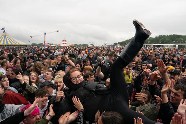 <p>A festivalgoer crowd surfs on the first day of Download Festival at Donington Park in Leicestershire</p>