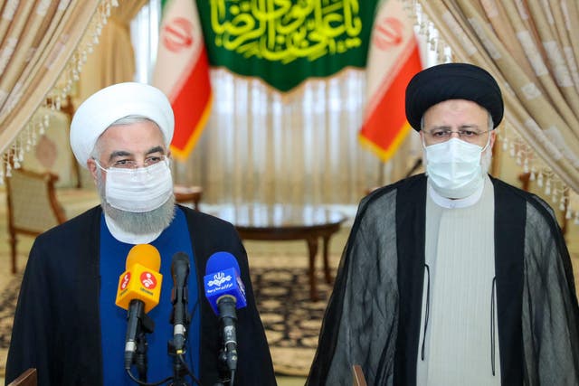 <p>Outgoing president Hassan Rouhani (L) takes part in a press conference with president-elect Ebrahim Raisi </p>
