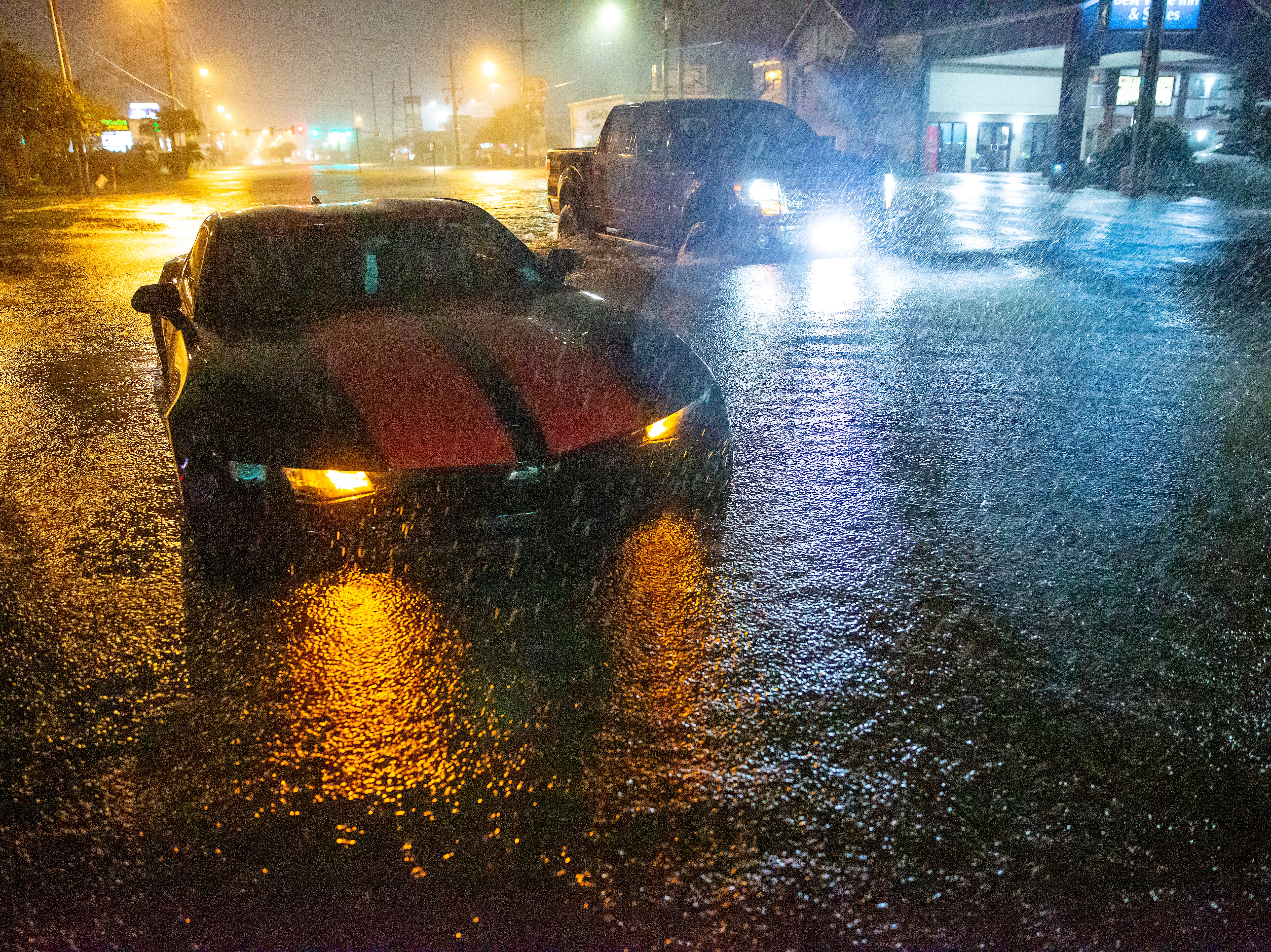 Motorists navigate a flooded Gause Boulevard in Slidell, Louisiana late on Friday 18 June 2021