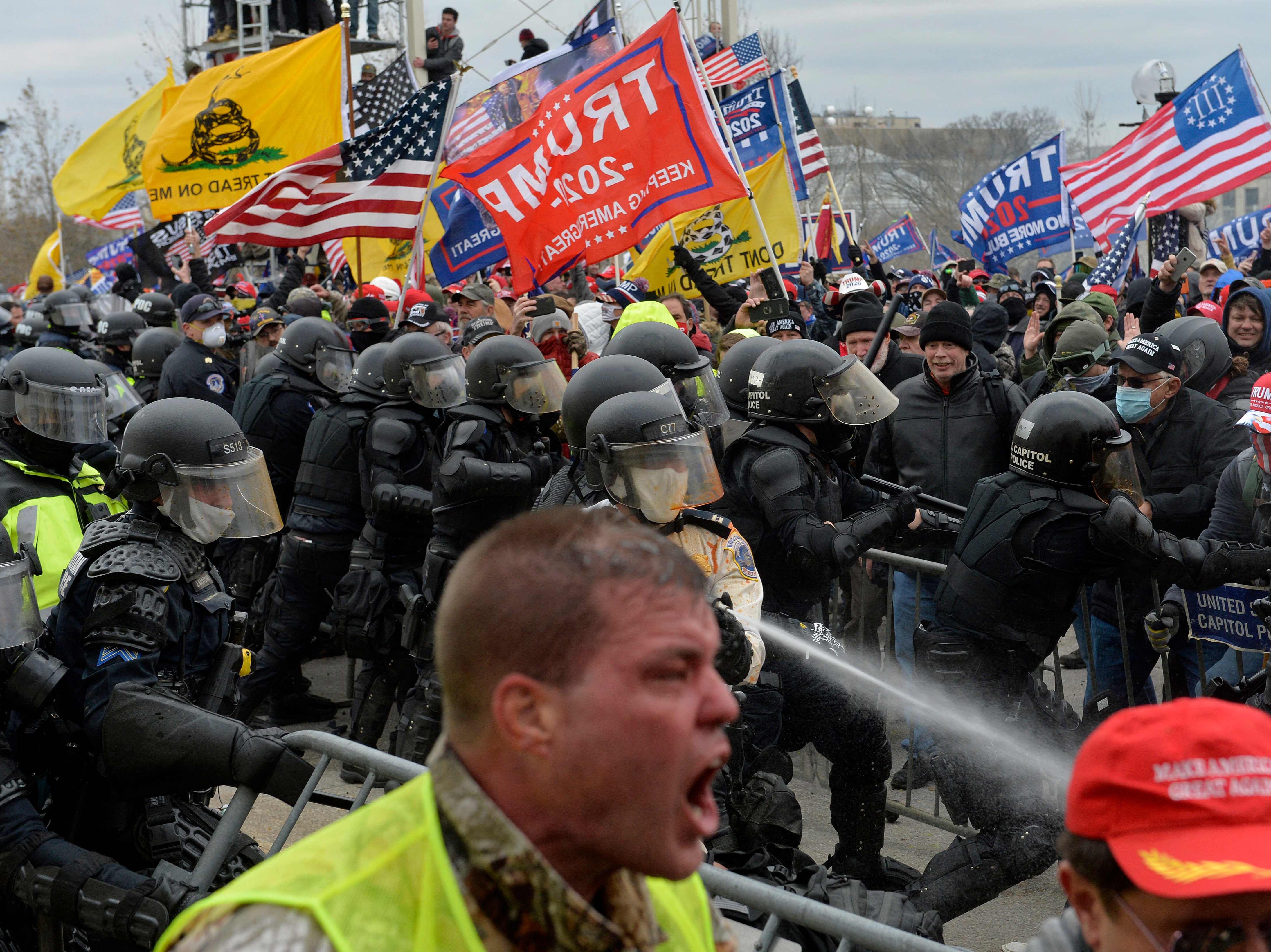 <p>Trump supporters clash with police and security forces as people try to storm the US Capitol in Washington DC on 6 January 2021</p>