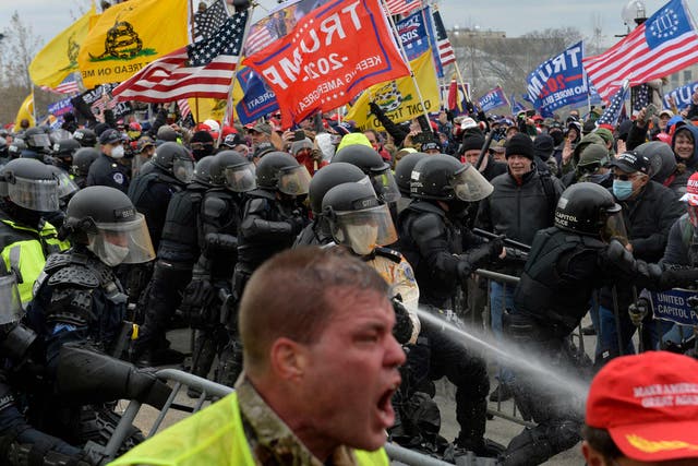 <p>Trump supporters clash with police and security forces as people try to storm the US Capitol in Washington DC on 6 January 2021</p>