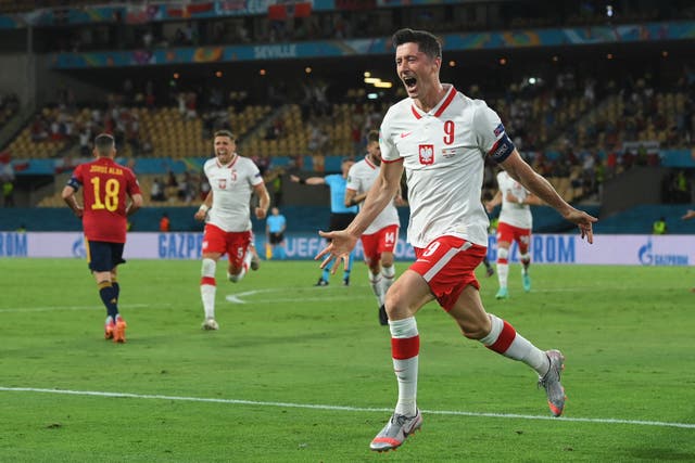 <p>Robert Lewandowski celebrates scoring Poland’s equaliser</p>