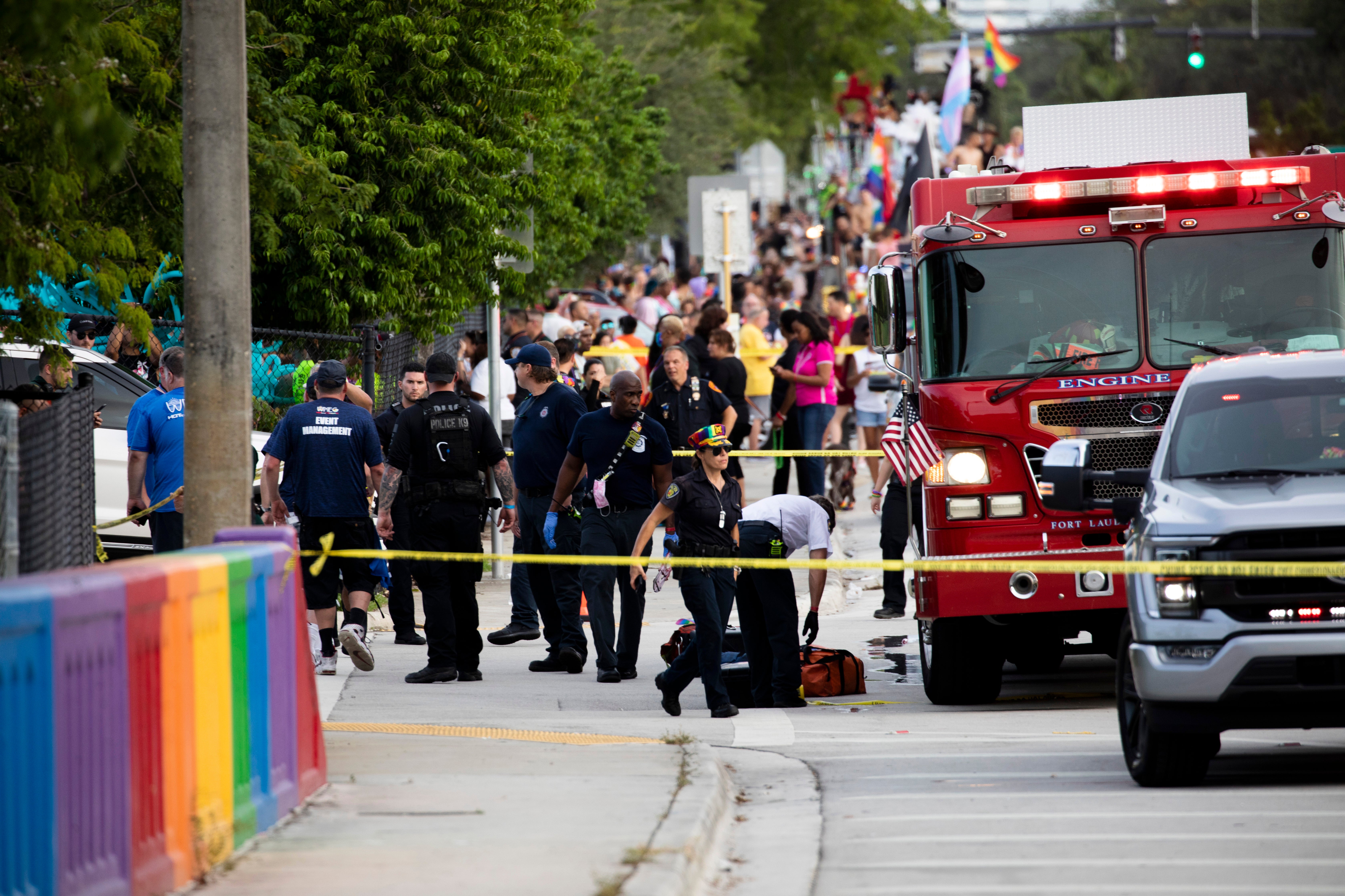Police and firefighters respond after a truck drove into a crowd of people during The Stonewall Pride Parade and Street Festival in Wilton Manors, Fla., on Saturday, June 19, 2021