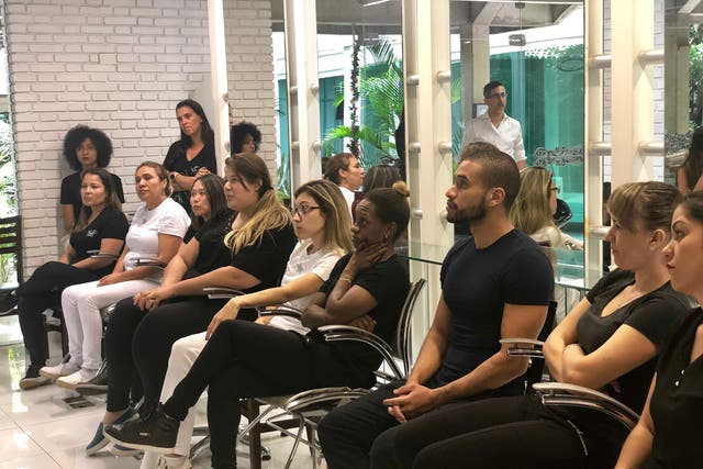 <p>Beauticians from Jacques Janine, a high end salon in São Paulo, being trained to stop domestic violence as part of the Mãos Empenhadas Contra a Violência project in 2019</p>
