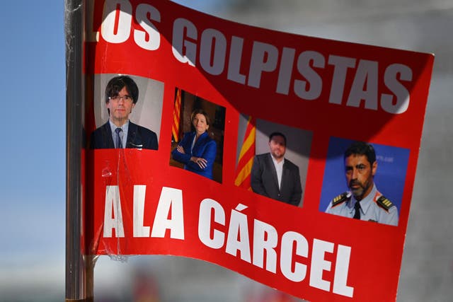 <p>A placard depicting Catalan leaders Carles Puigdemont, Carme Forcadell, Oriol Junqueras and former head of Catalonia's police force, Josep Lluis Trapero, reading ‘To jail’</p>