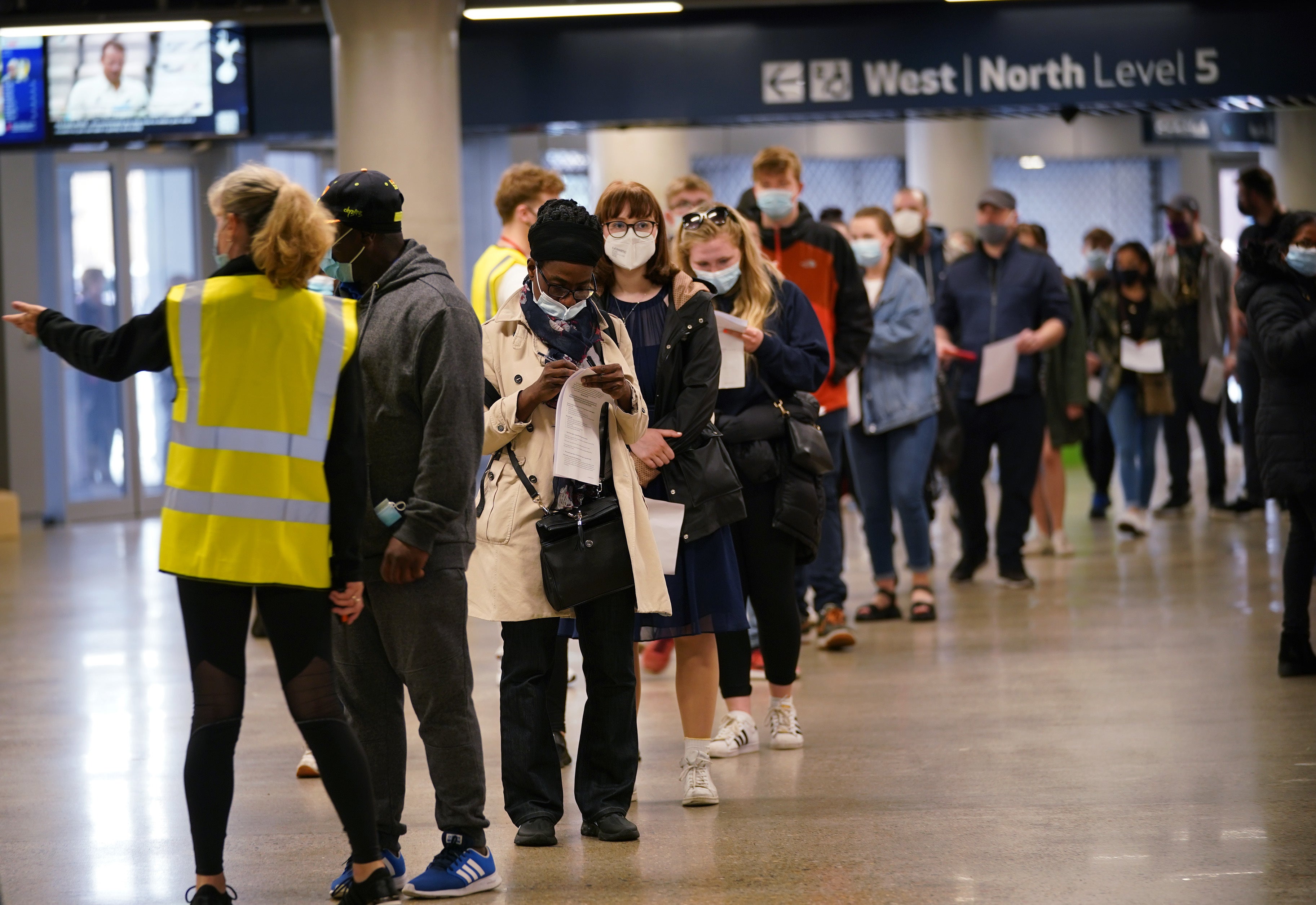 People queue at an NHS Vaccination Clinic at Tottenham Hotspur’s stadium in north London