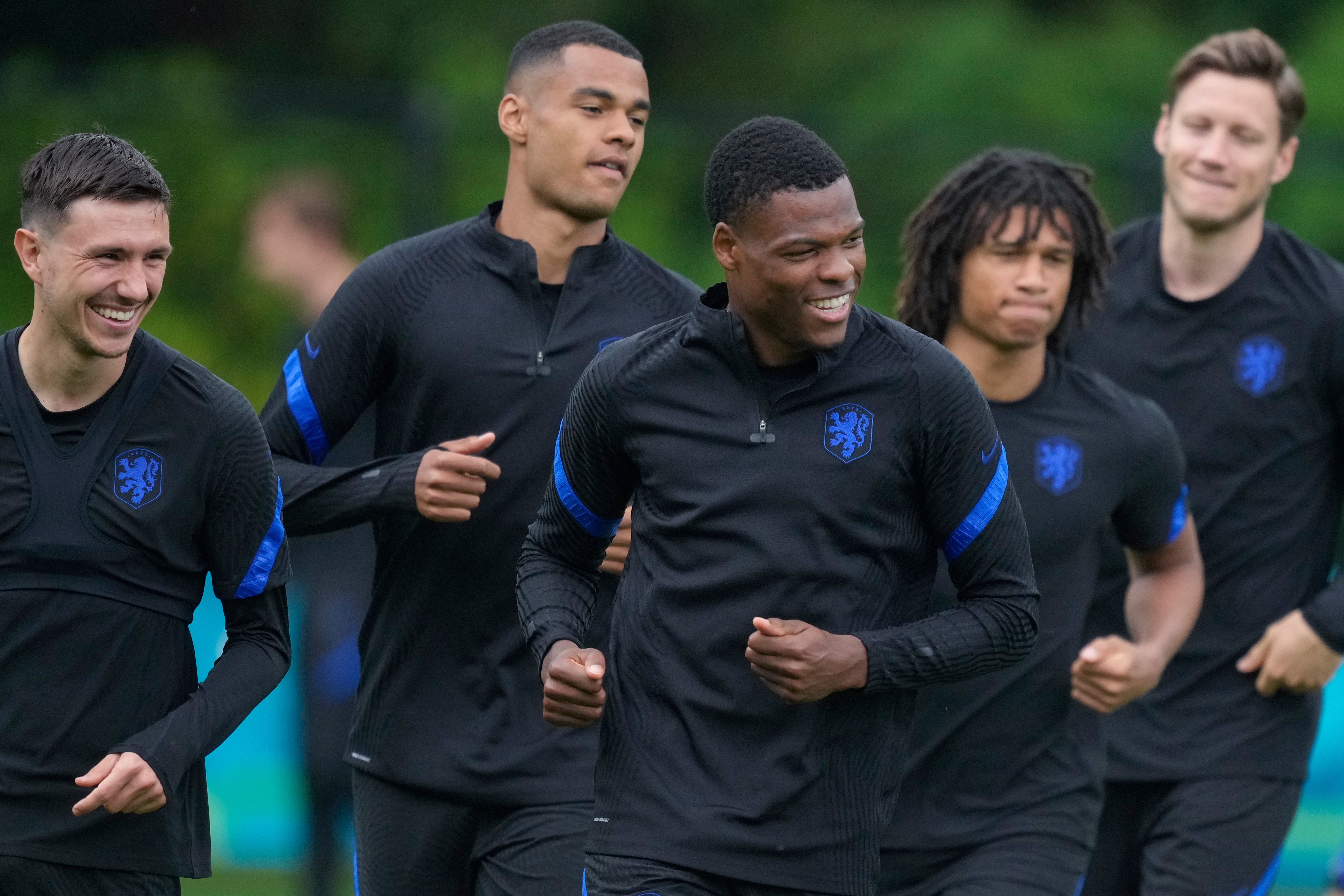 Netherlands players, from left, Steven Berghuis, Cody Gakpo, Denzel Dumfries, Nathan Ake, and Wout Weghorst, warm up during training on Sunday